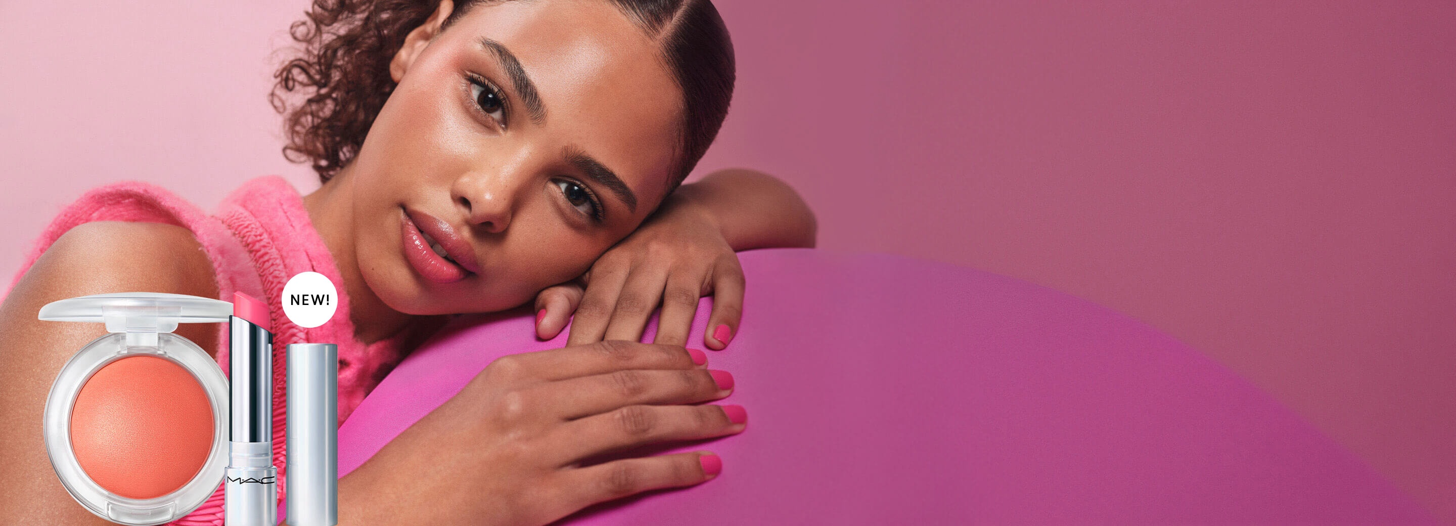Model wearing MAC GlowPlay Blush and Lip Balm on a pink background